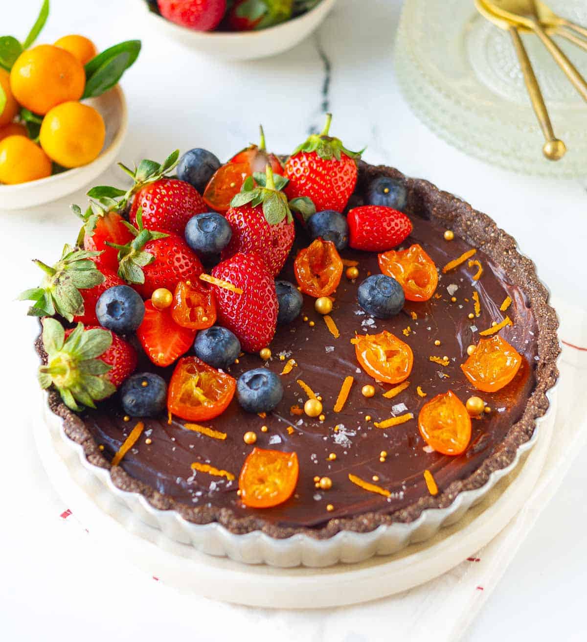 Finished chocolate tart on a plate.