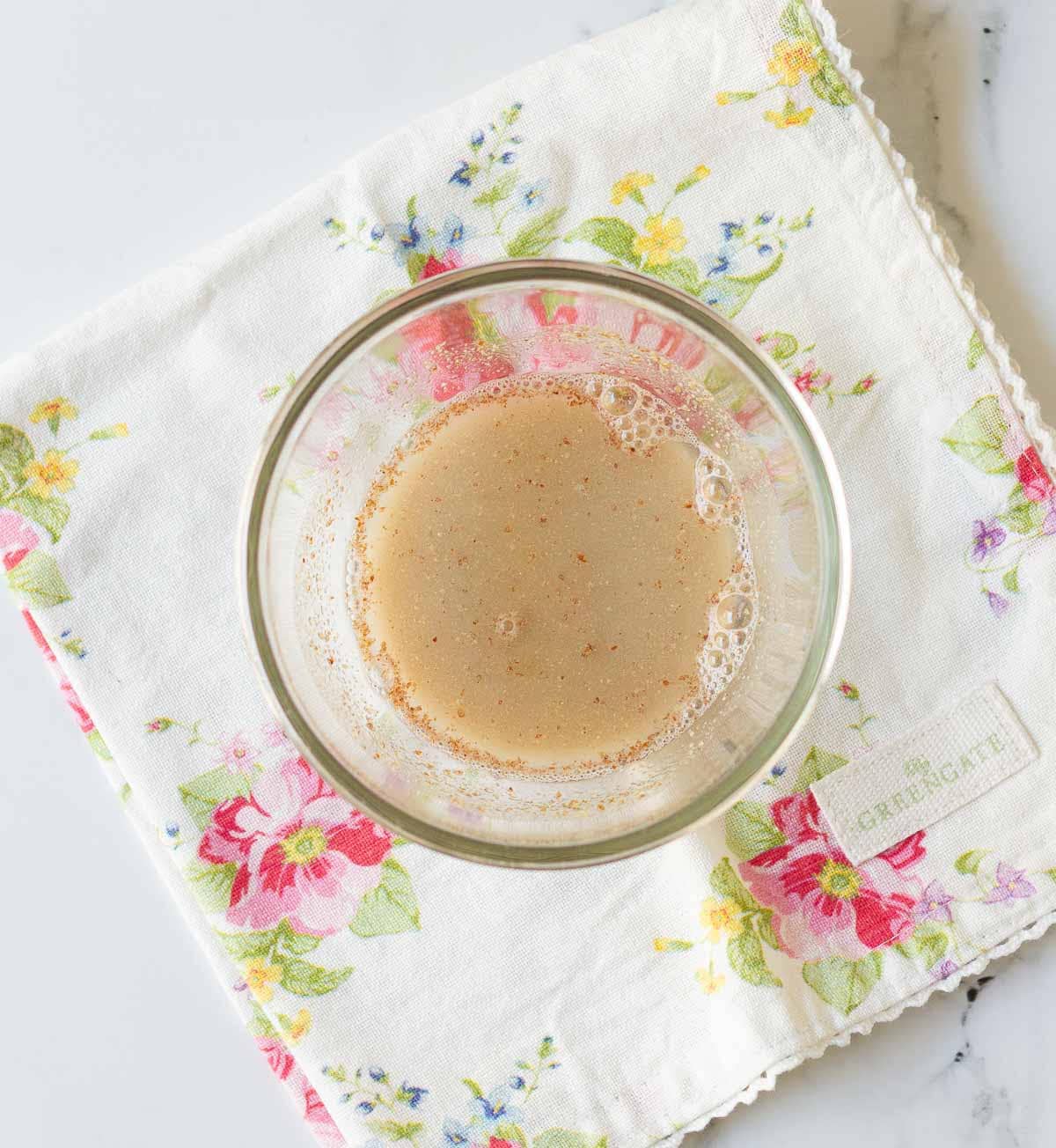 Mixture of water and flaxmeal in a small bowl.