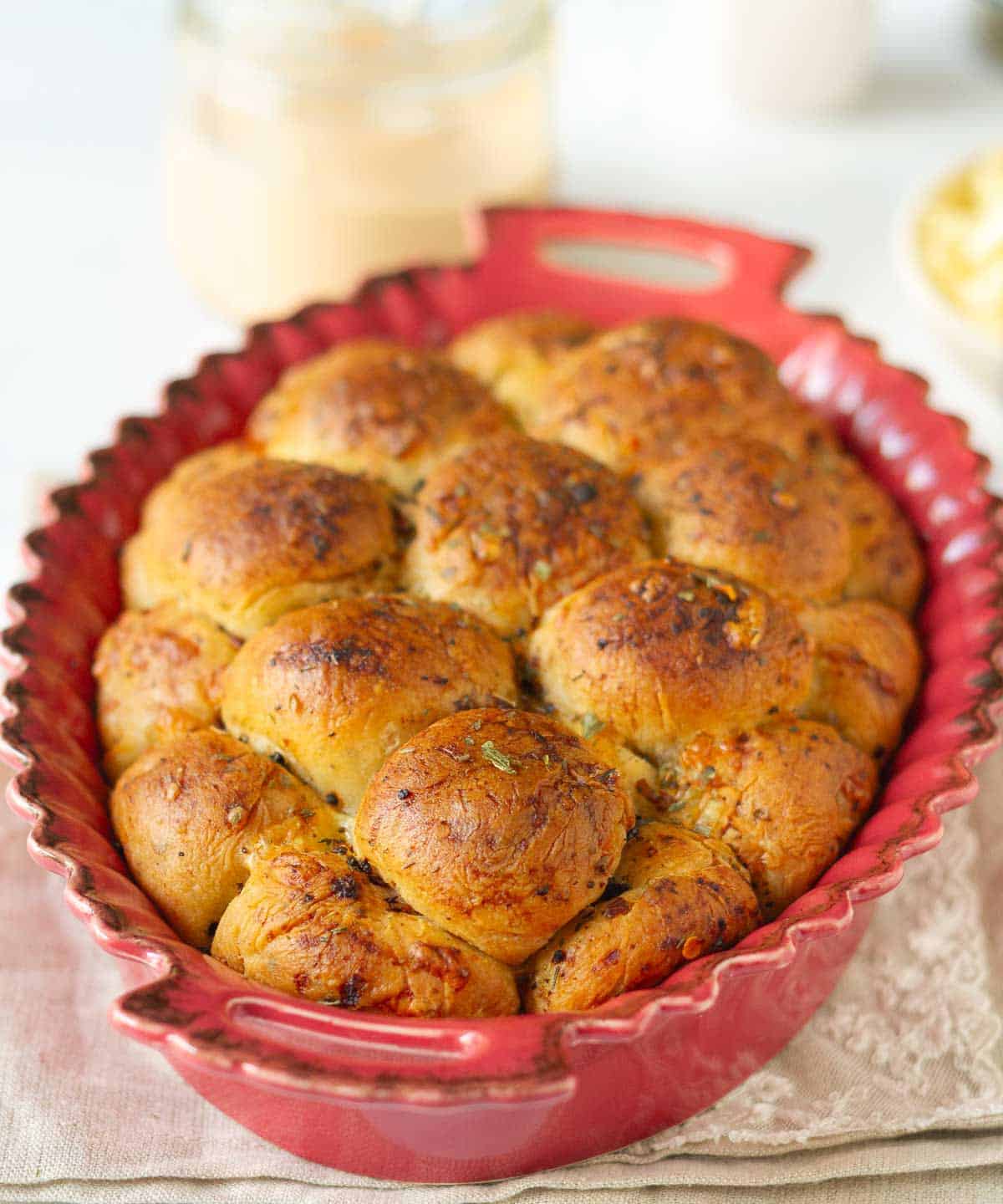 Bubble bread in a red casserole dish.