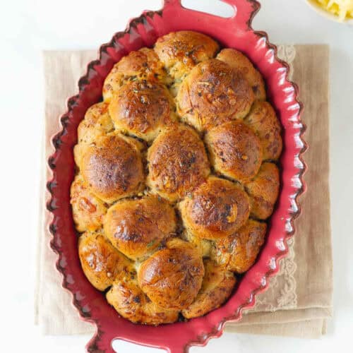 Cheesy bubble bread in a baking dish.