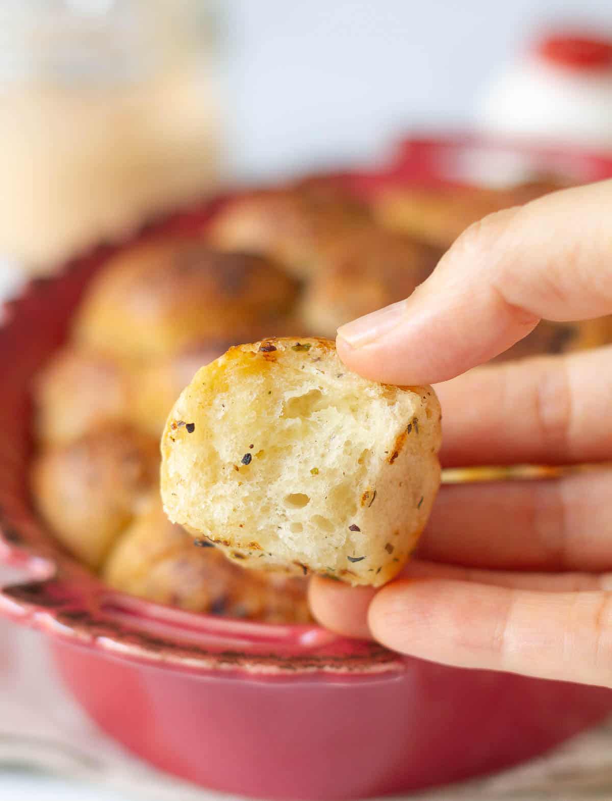 A piece bread in a hand.