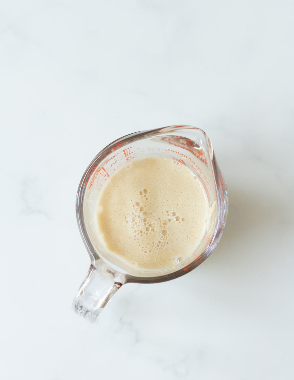 Bubbly yeast mixture in a cup.