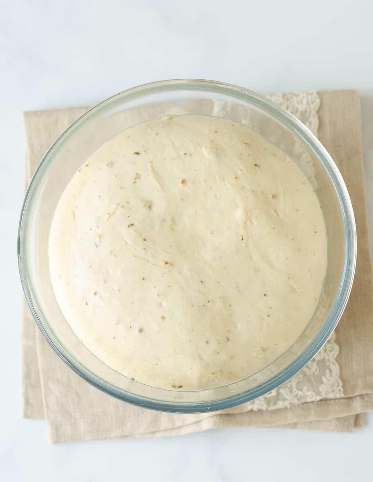 Proofed dough in a bowl.