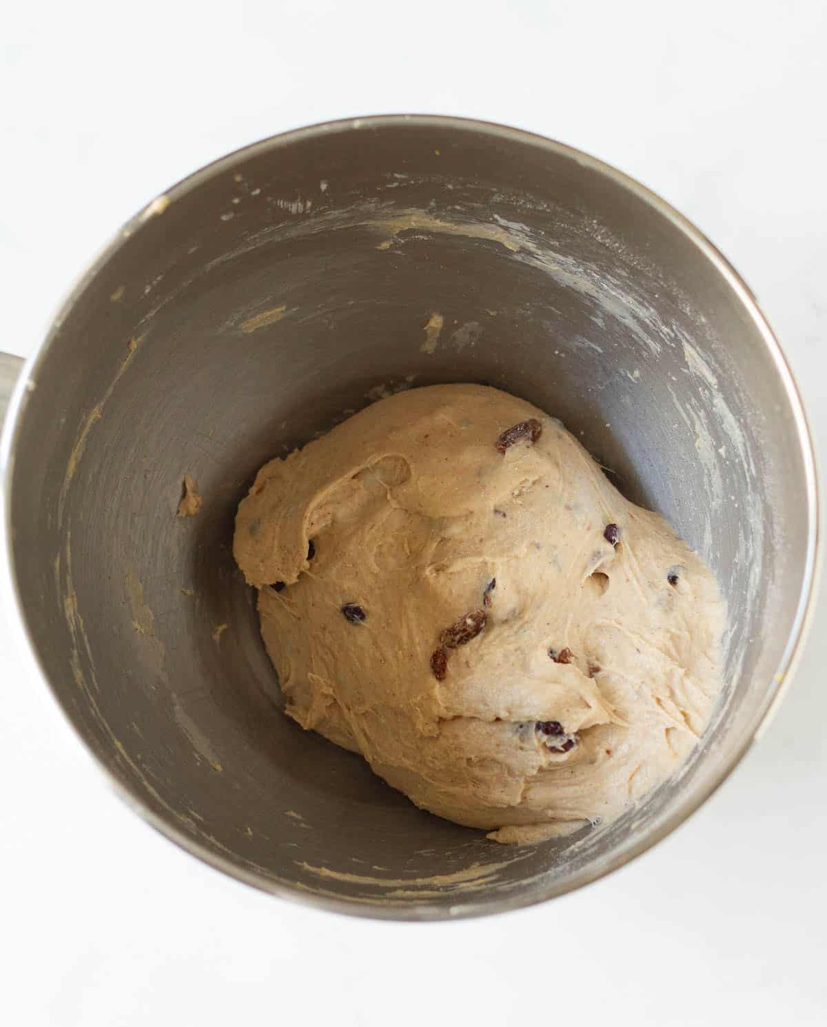 Kneaded hot cross buns dough in a stand mixer bowl.