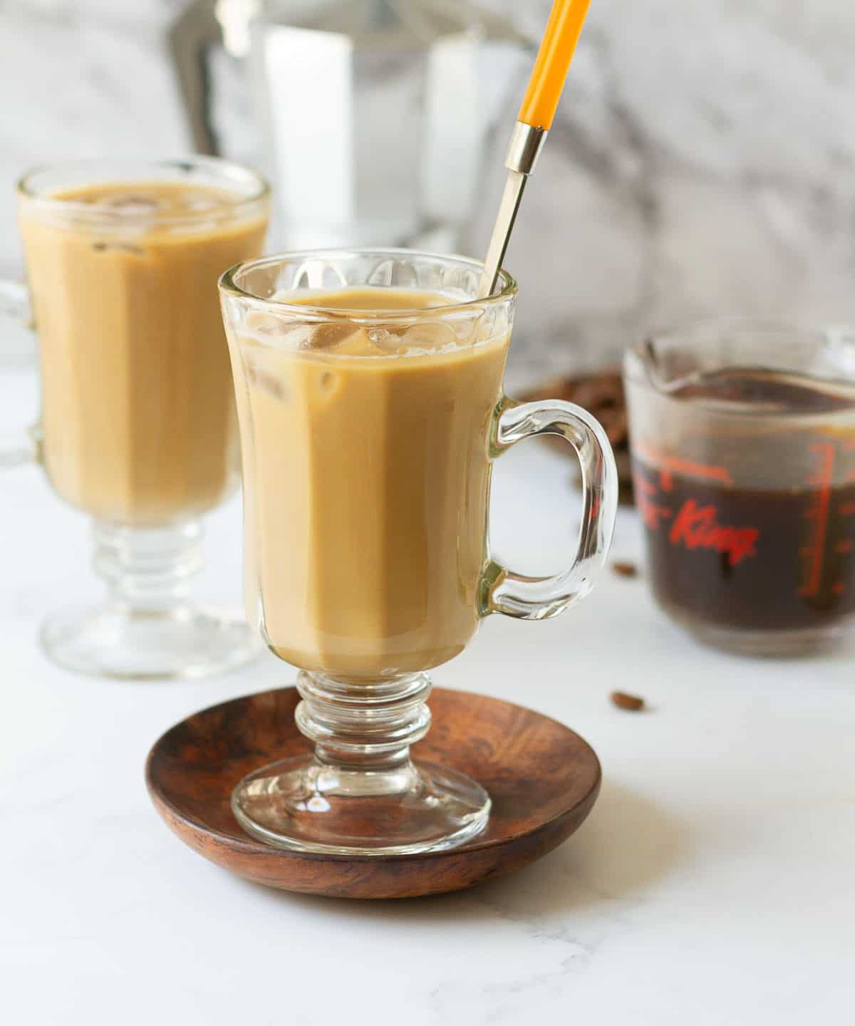 Vietnamese iced coffee in 2 cups with a spoon in one cup.