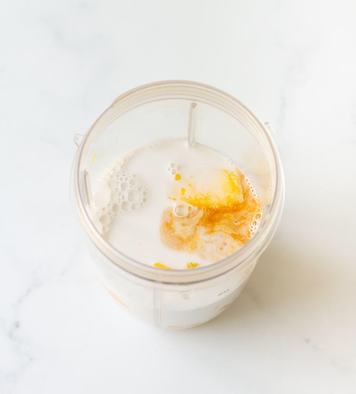 mango and coconut milk in a blender jar.