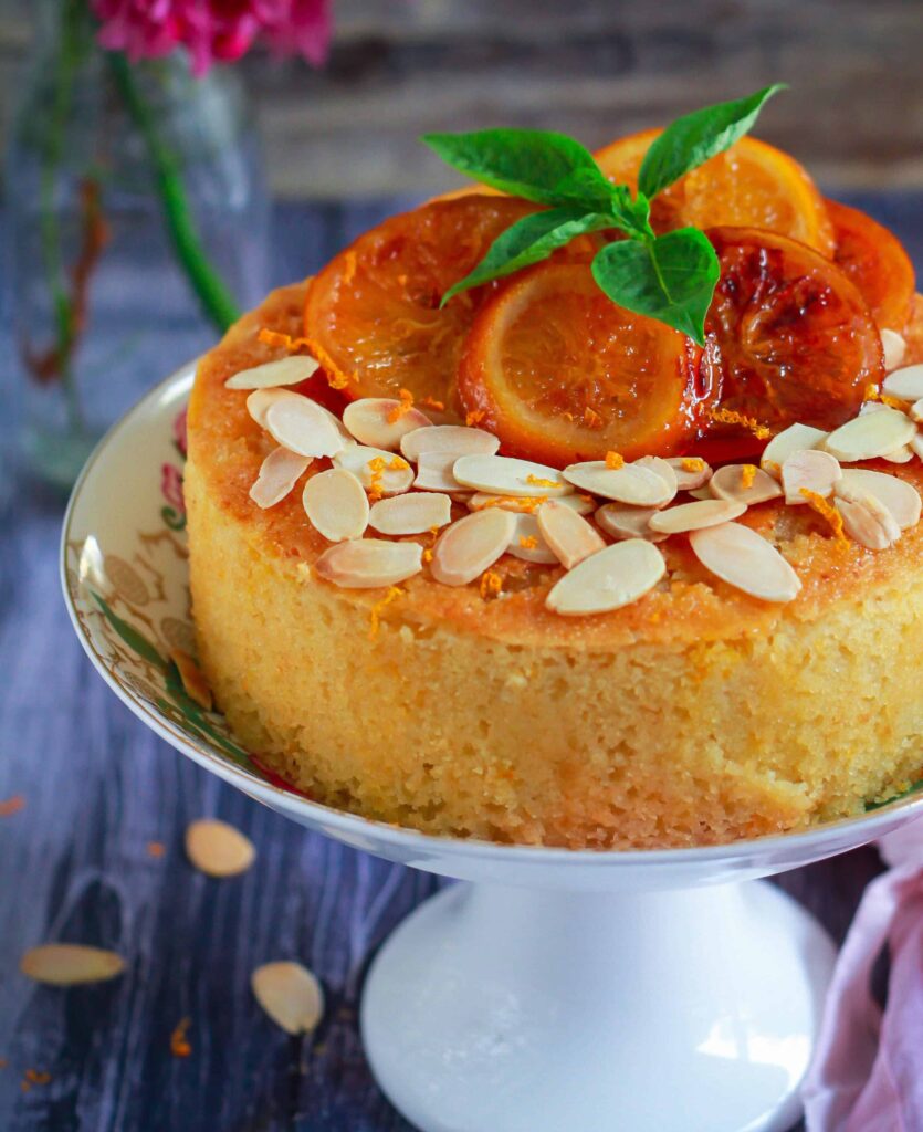 Orange Semolina Almond Cake on a cake stand.