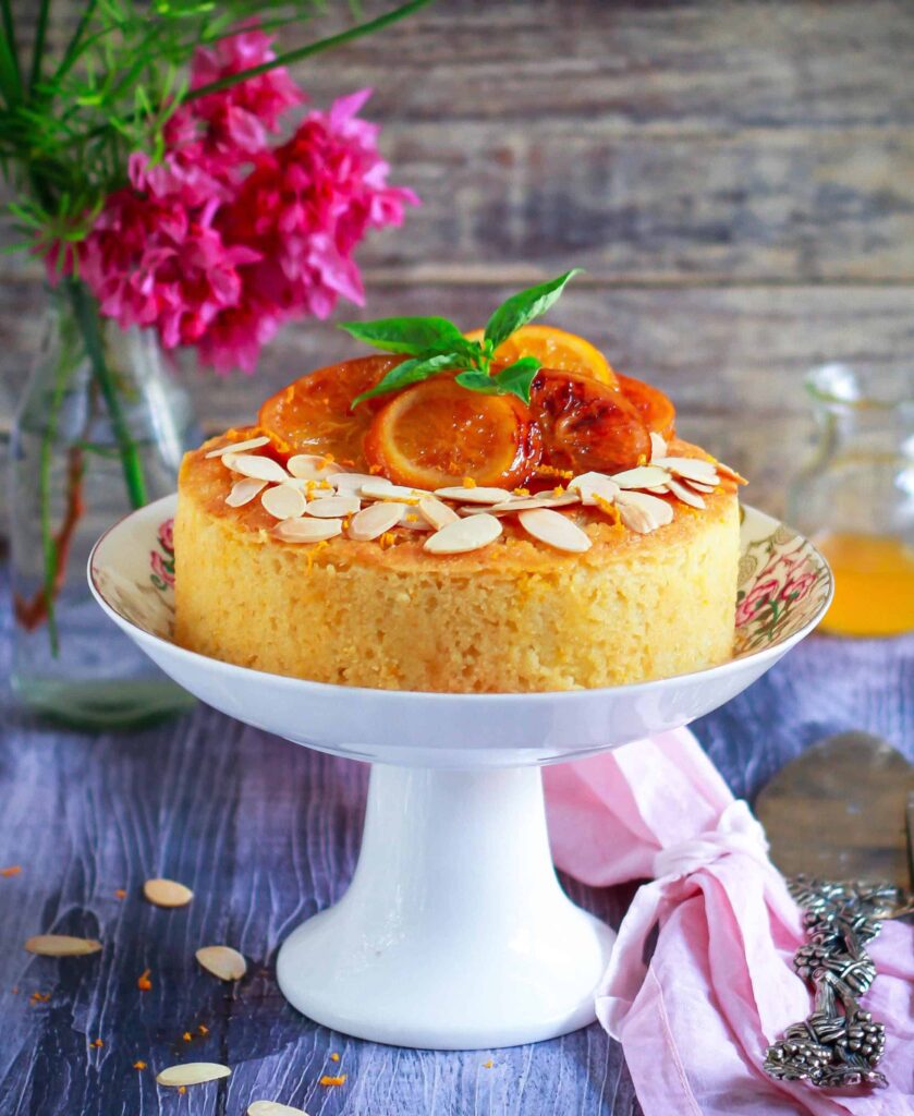 Orange Semolina Almond Cake on a cake stand.