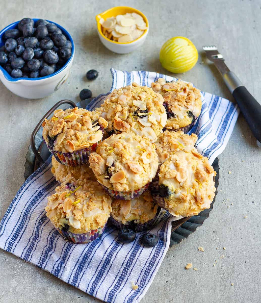 Lemon blueberry muffins on a blue and white striped napkin.