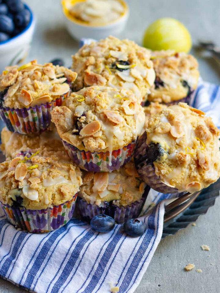 Blueberry Muffins on a blue striped napkin on a wire rack.