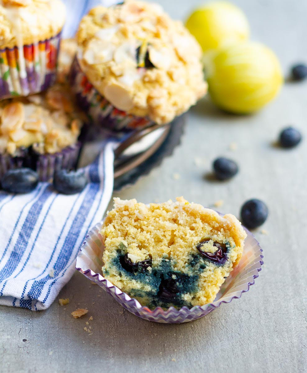 Half a muffin in a paper liner to show the fluffy interior.