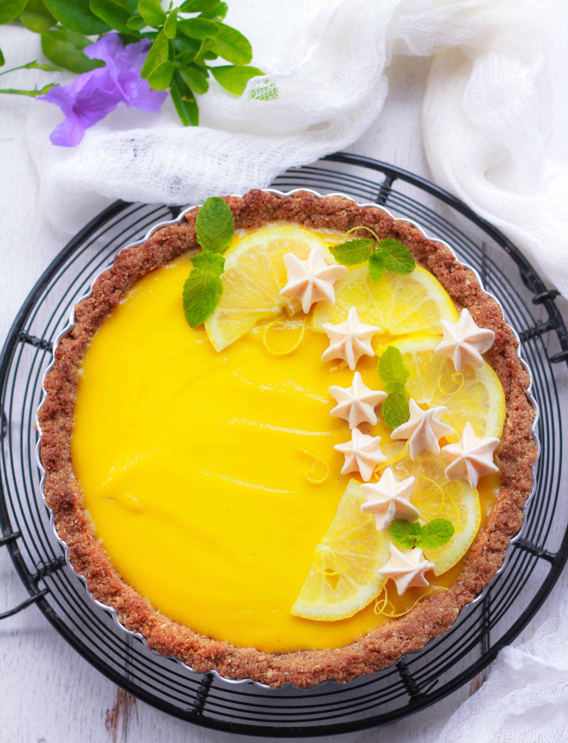 Vegan Lemon Tart in a tart pan on a trivet.