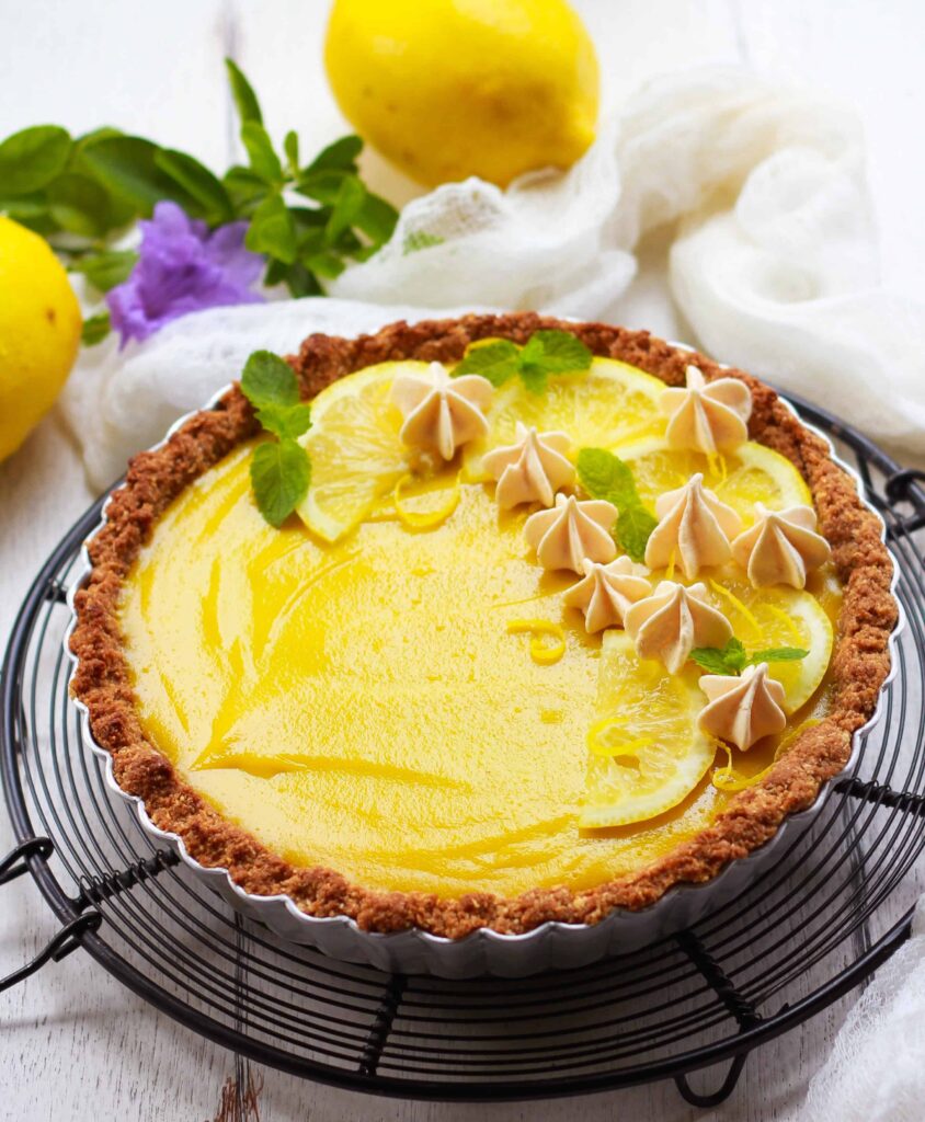 lemon tart in a trat pan on a trivet.