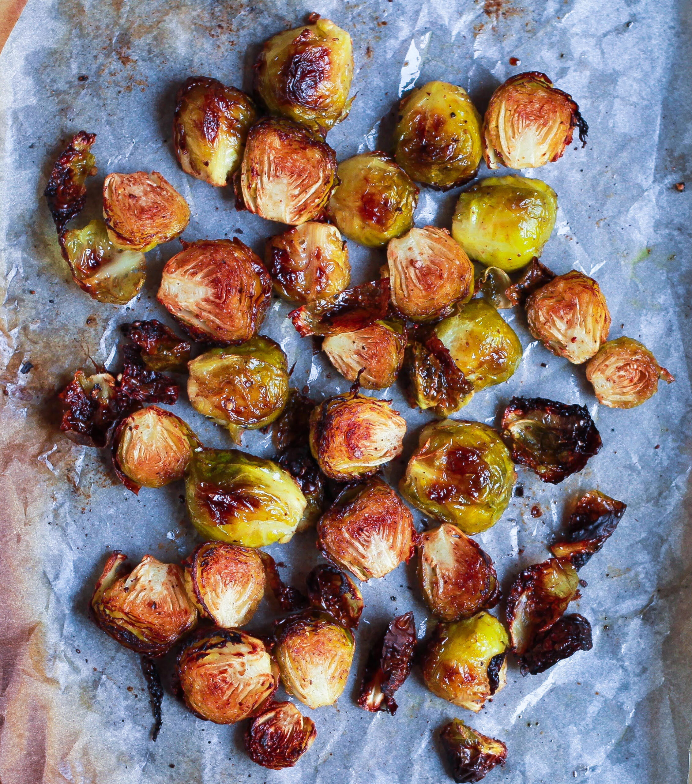 roasted brussels sprouts on a parchment lined tray.