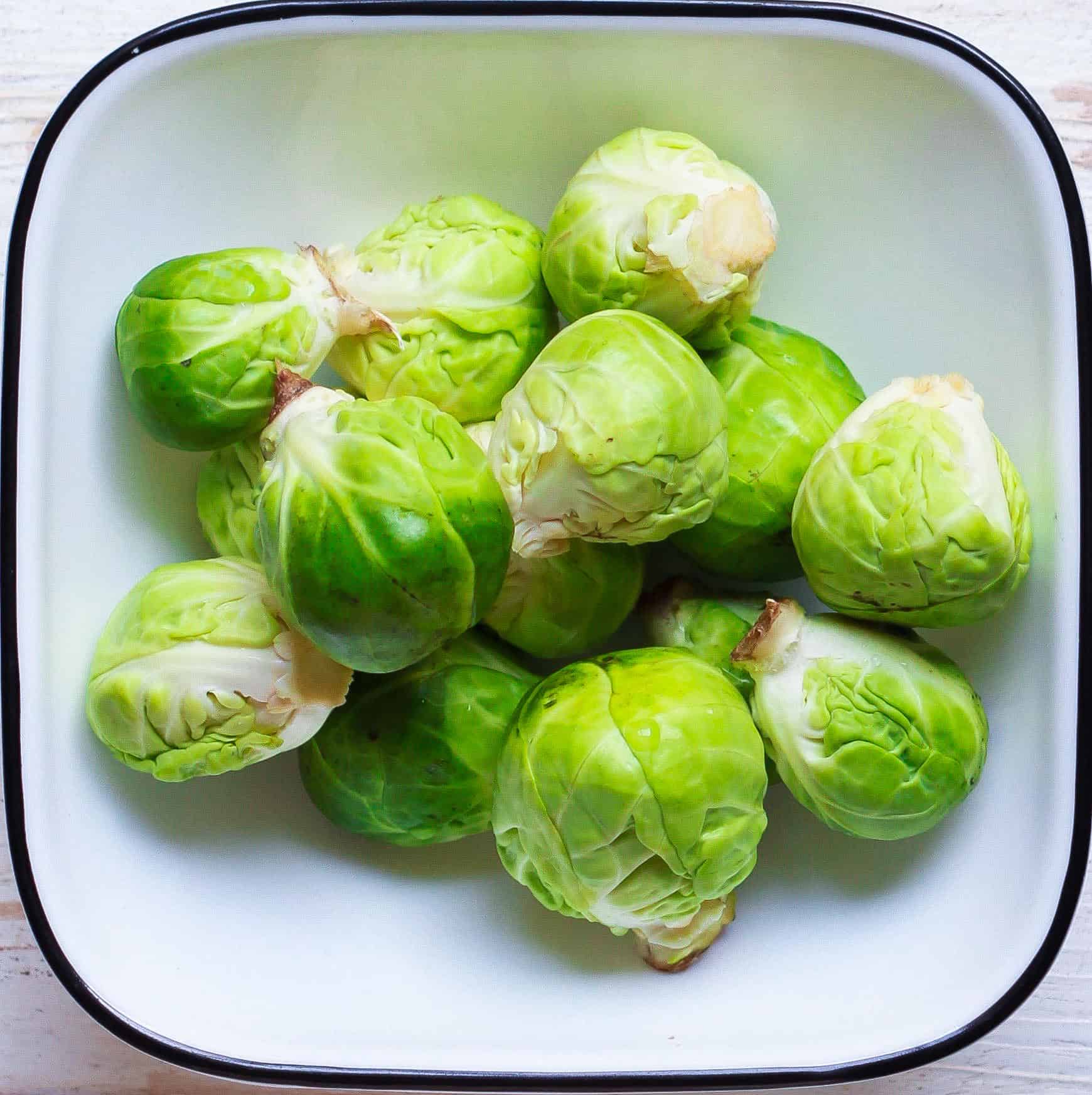 Brussel Sprouts in a white bowl.