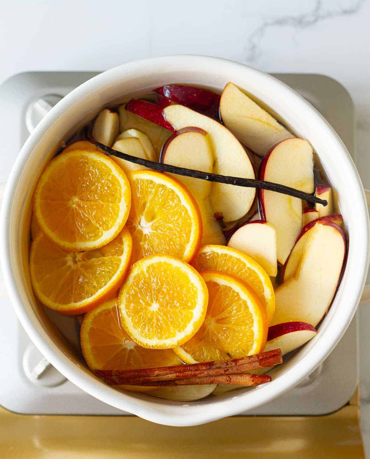 All ingredients in a white enamel pot.