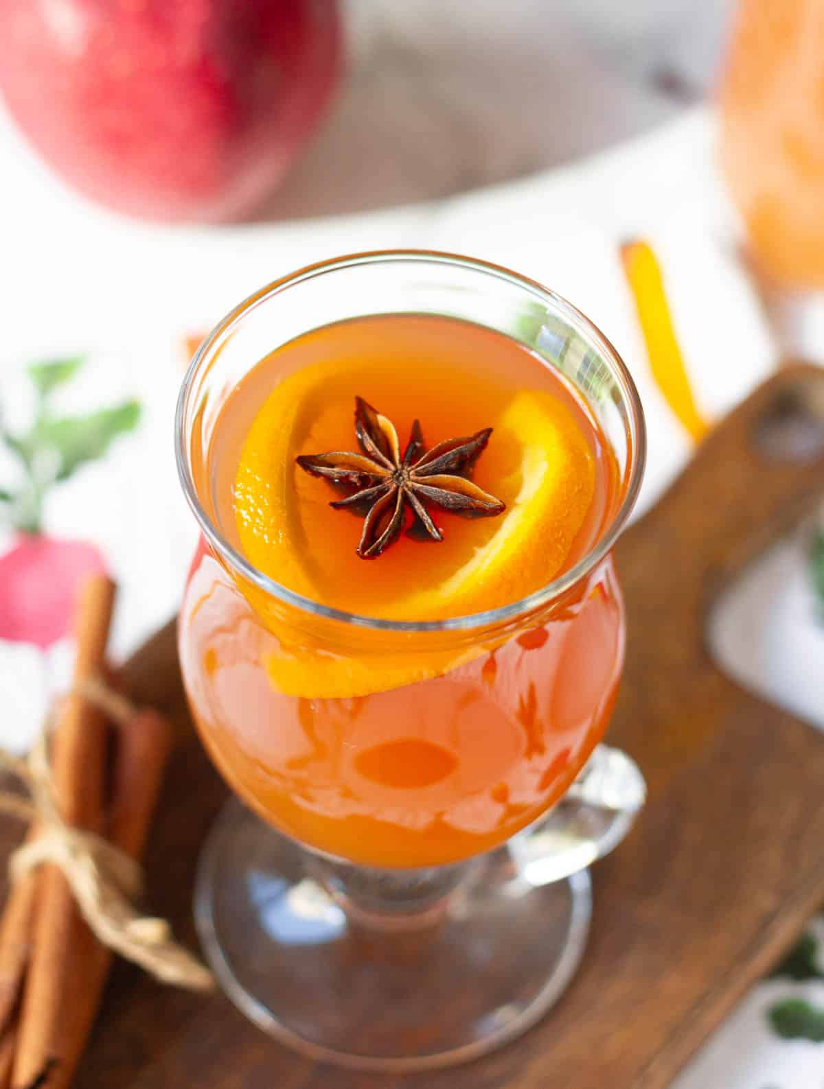 Apple cider garnished with orange slices and star anise.