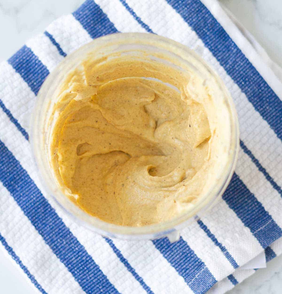 blended ingredients in a blender jar on a blue striped napkin.