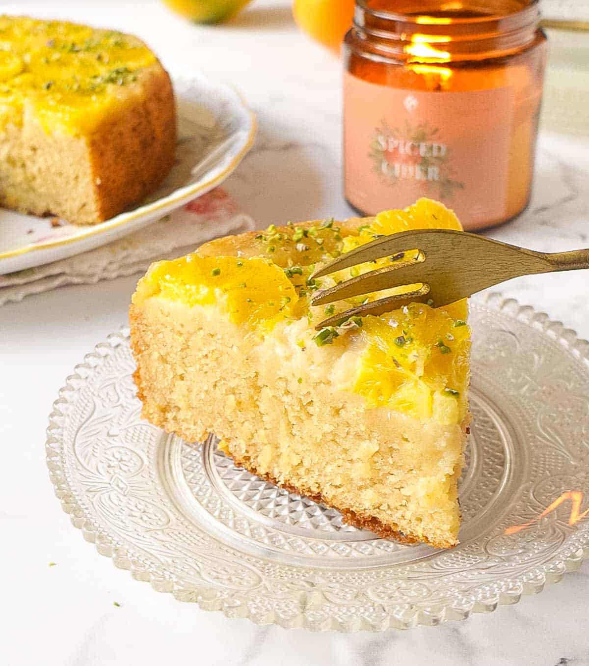A slice of cake on a plate with a fork on top.