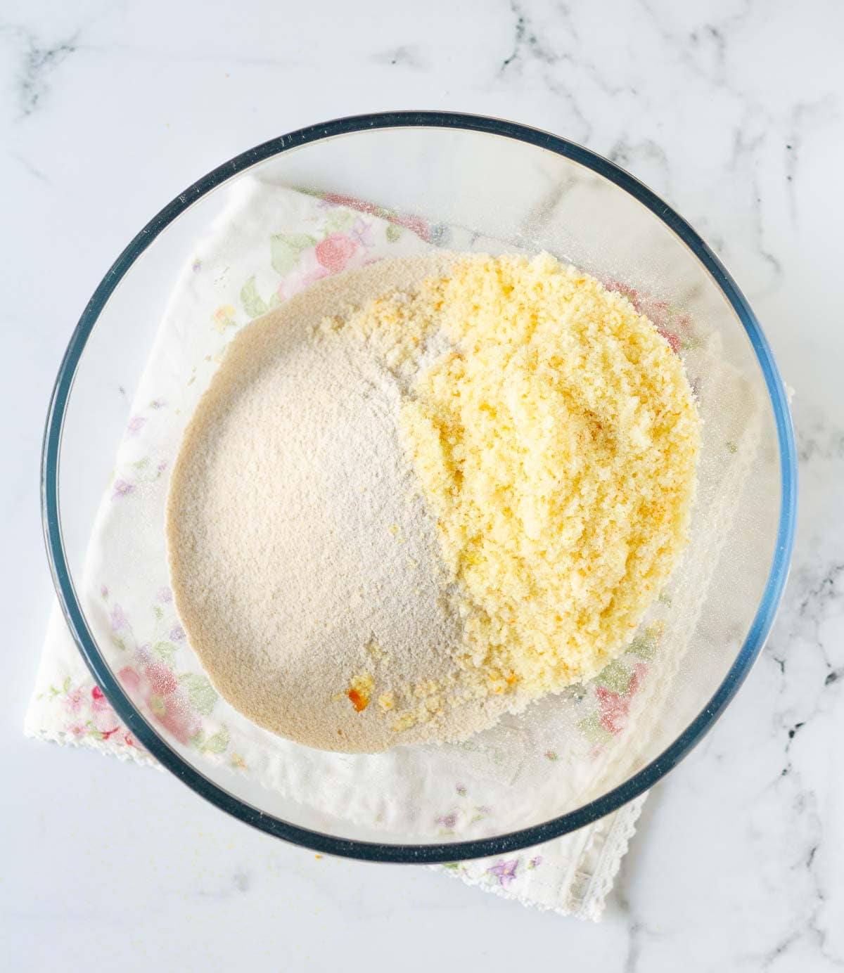 Flour and orange zested sugar in a mixing bowl.