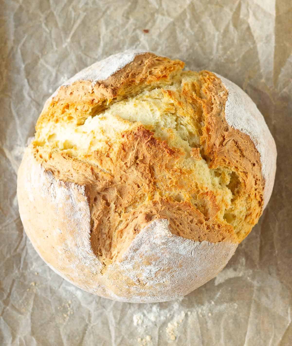 Baked Irish soda bread on parchment paper.