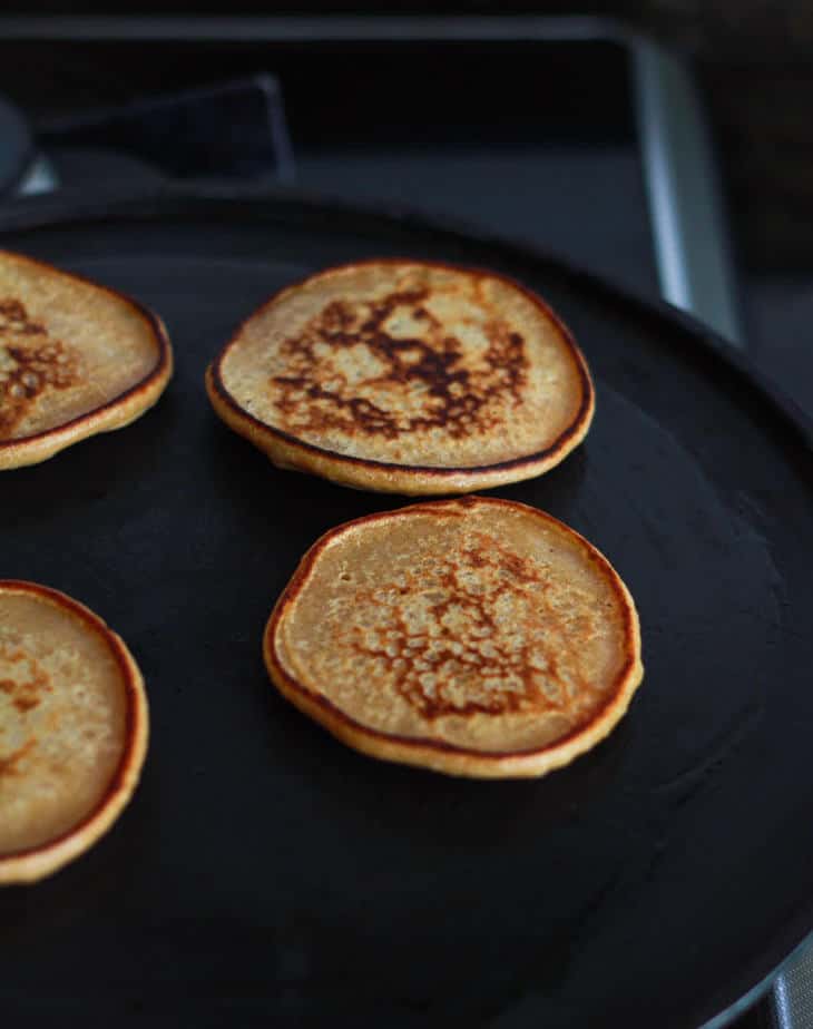 Flipped banana pancakes on a griddle.