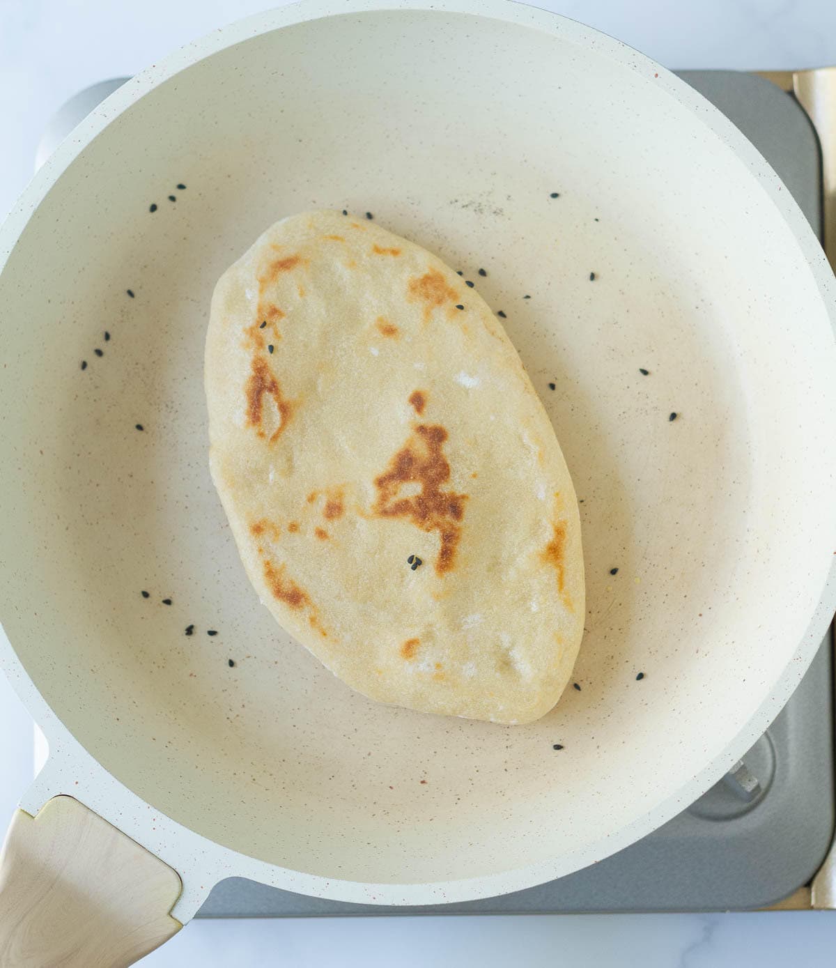 Cooked naan in a pan.