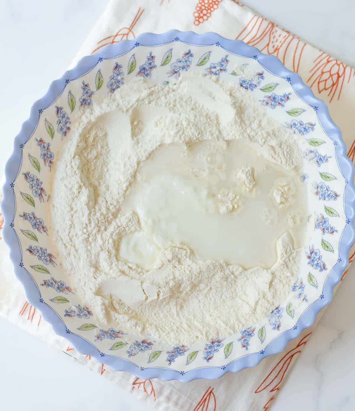 Flour, water, and yogurt in a bowl.