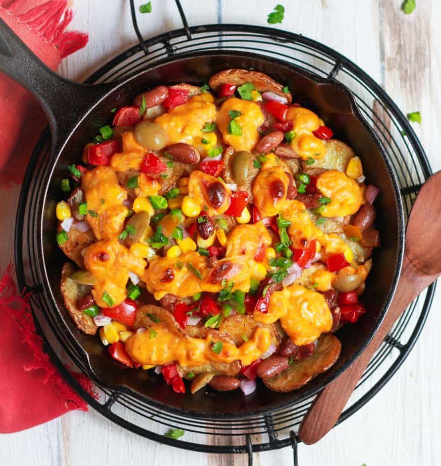 Loaded Potato Nachos in a cast iron skillet.