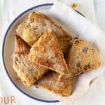 Banana scones with walnuts and chocolate chips in a bowl with a napkin.