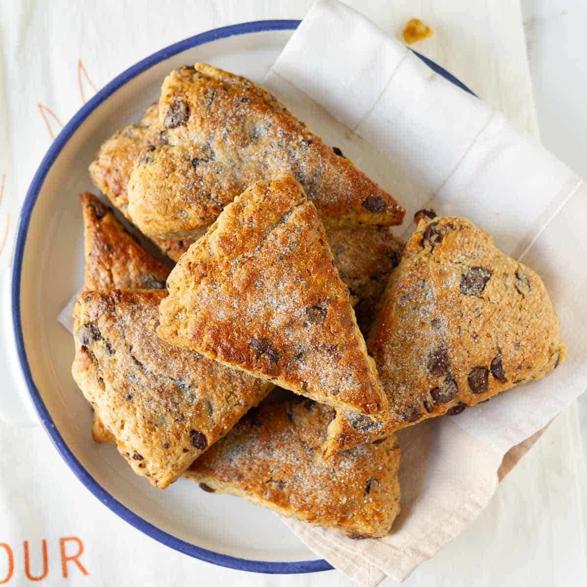 Banana scones with walnuts and chocolate chips in a bowl with a napkin.