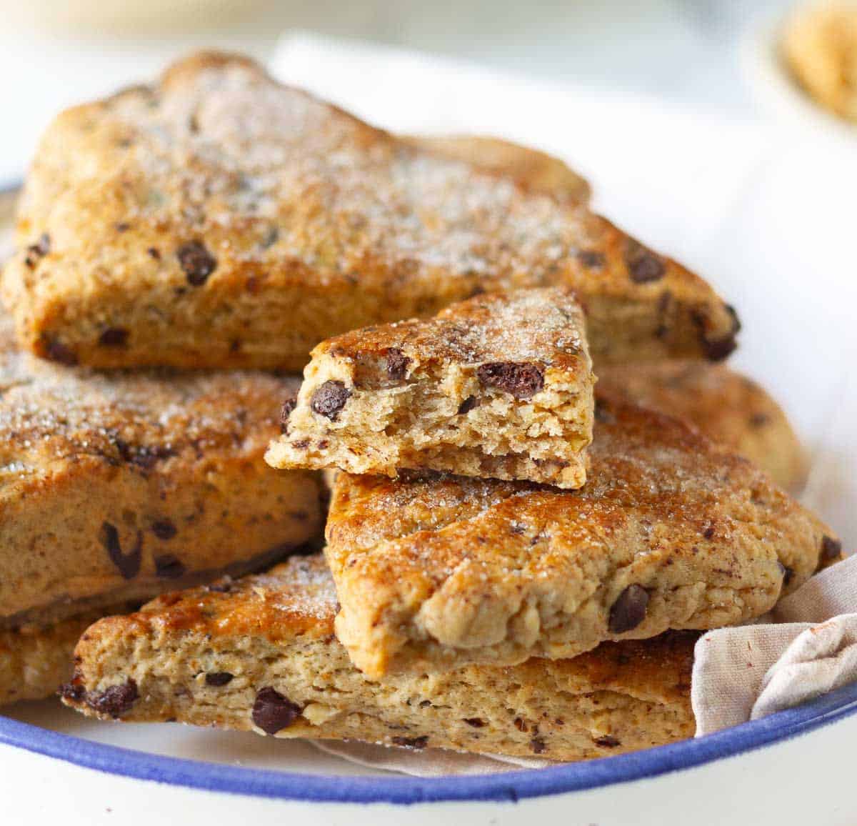 A bowl of scones with one half a scone to show the cross section.