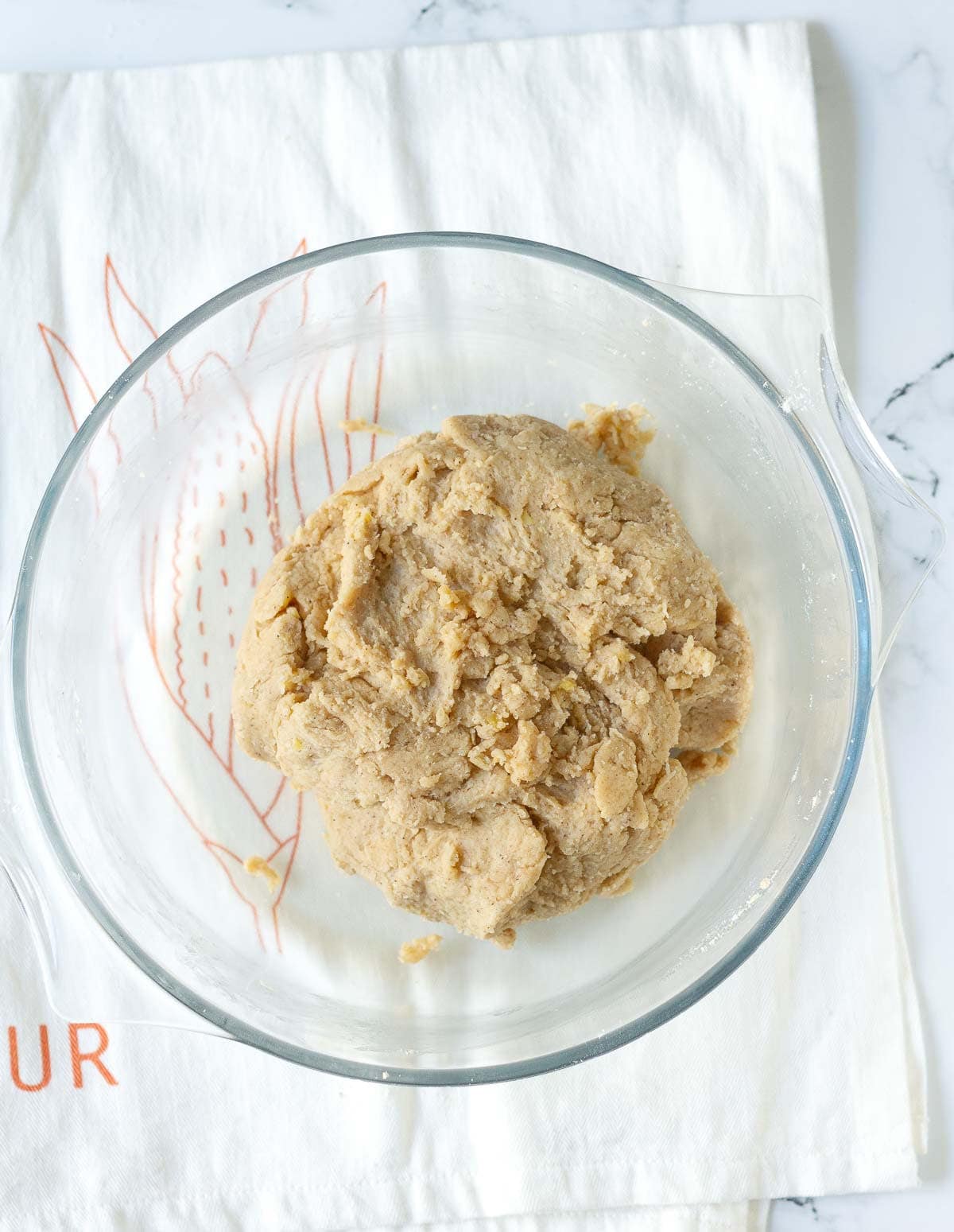 Dough in a glass bowl.