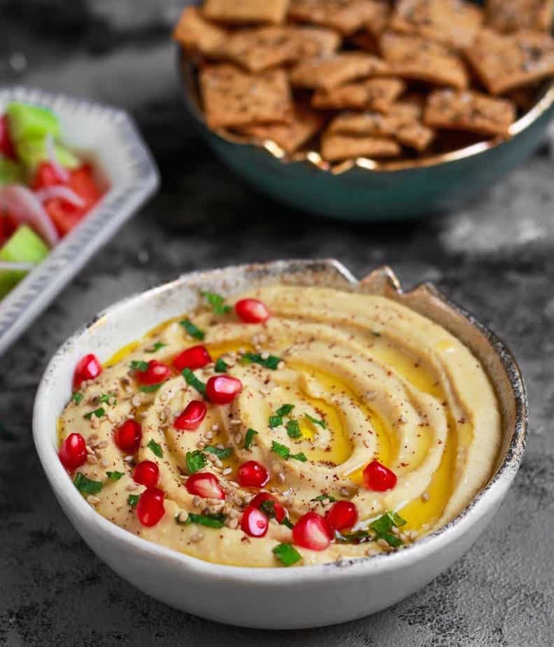 Hummus in a bowl with crackers.