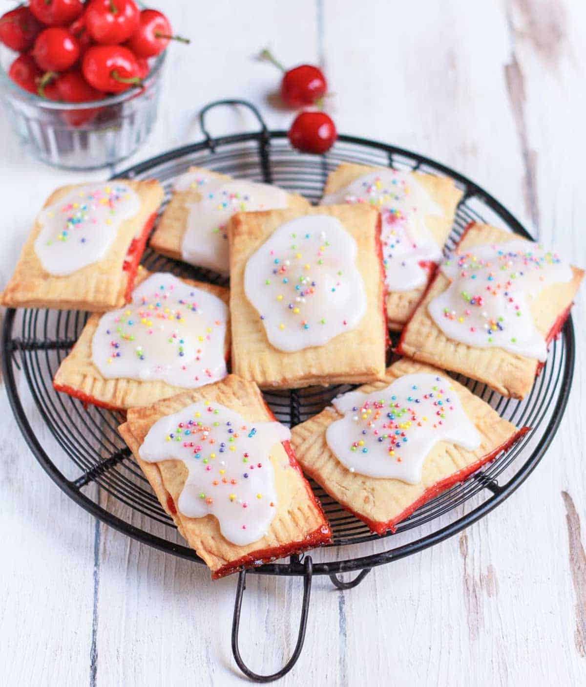 pop tarts on a metal trivet with cherries in the background.