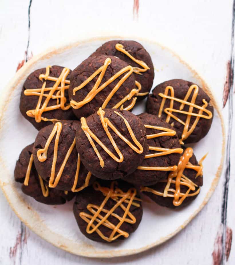 vegan chocolate peanut butter cookies with peanut butter glaze on a plate.