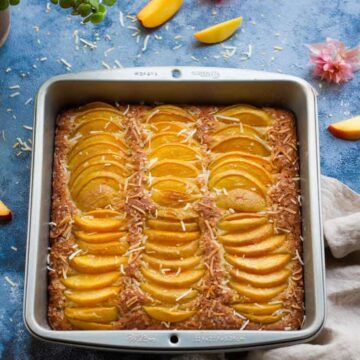 Eggless Coconut Peach Cake in a square baking pan.