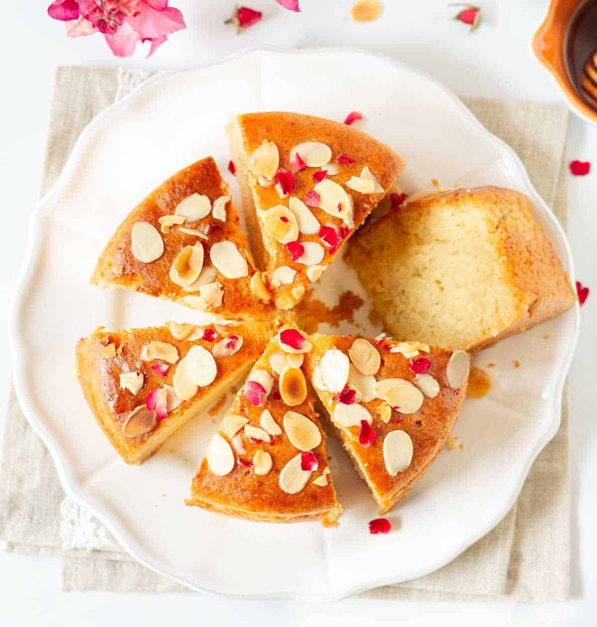 Sliced almond cake on a platter.