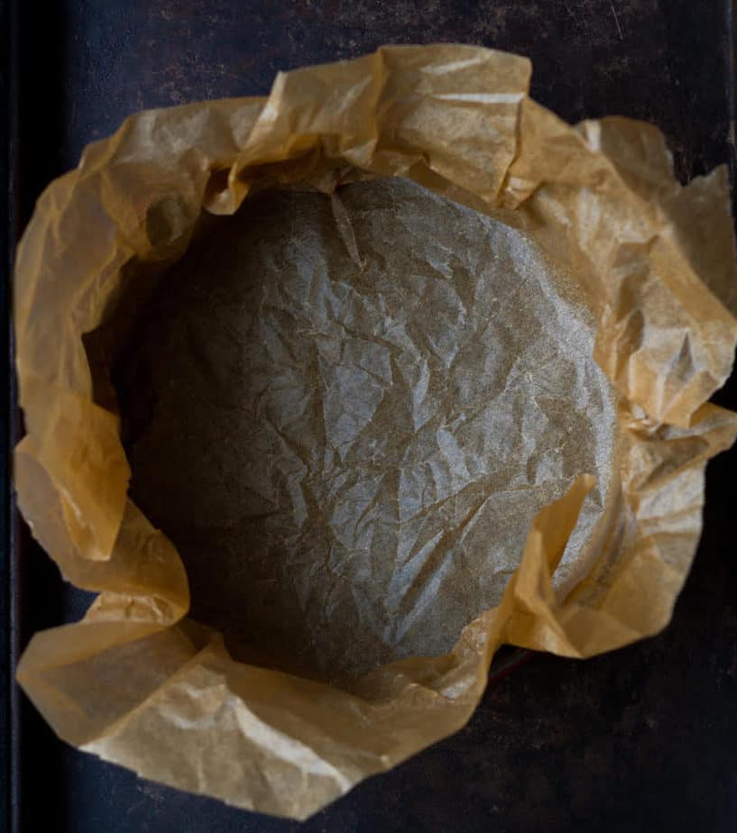 Parchment paper lined pan for Burnt Basque Cheesecake.