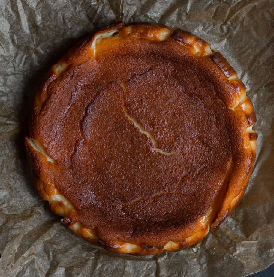 Baked basque cheesecake on parchment paper.