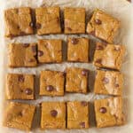 16 squares on blondies on parchment paper.