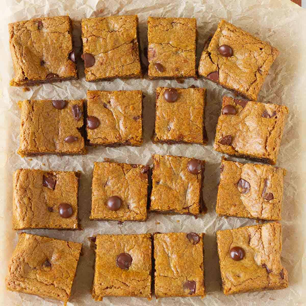 16 squares on blondies on parchment paper.
