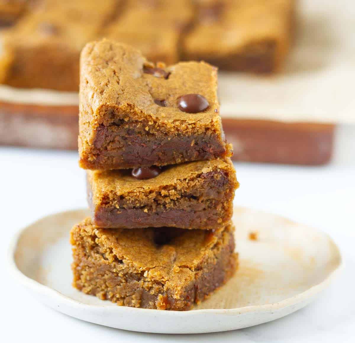 A stack of 3 blondies on a small plate.