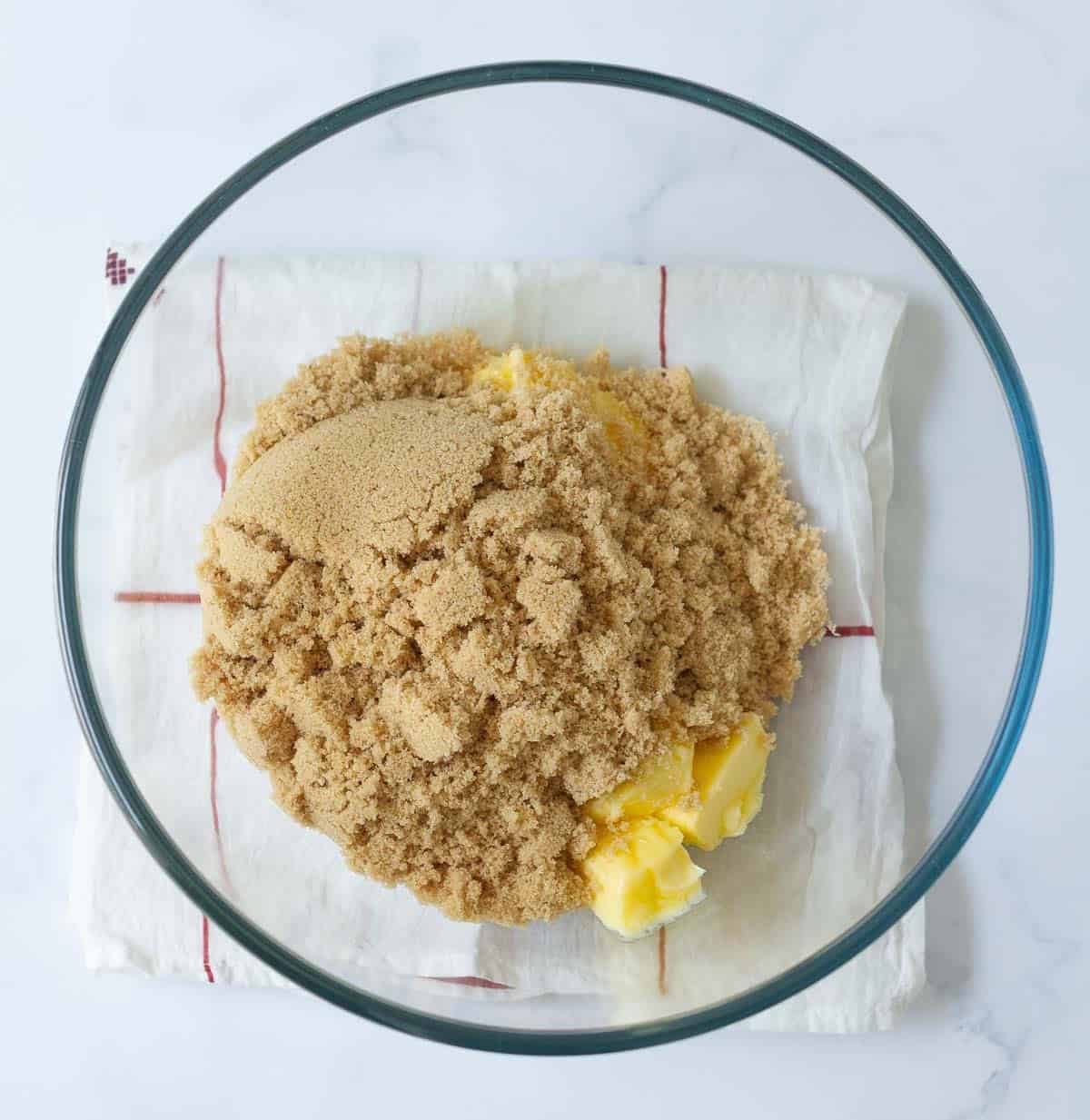 butter and brown sugar in a glass mixing bowl.