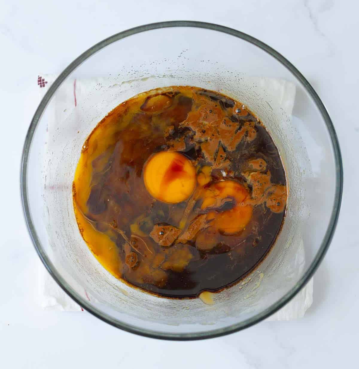 Eggs, coffee, and vanilla extract in a bowl.