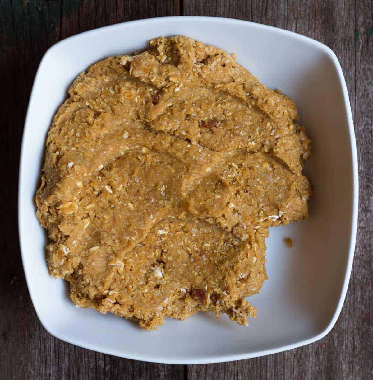 Protein ball dough in a white bowl.