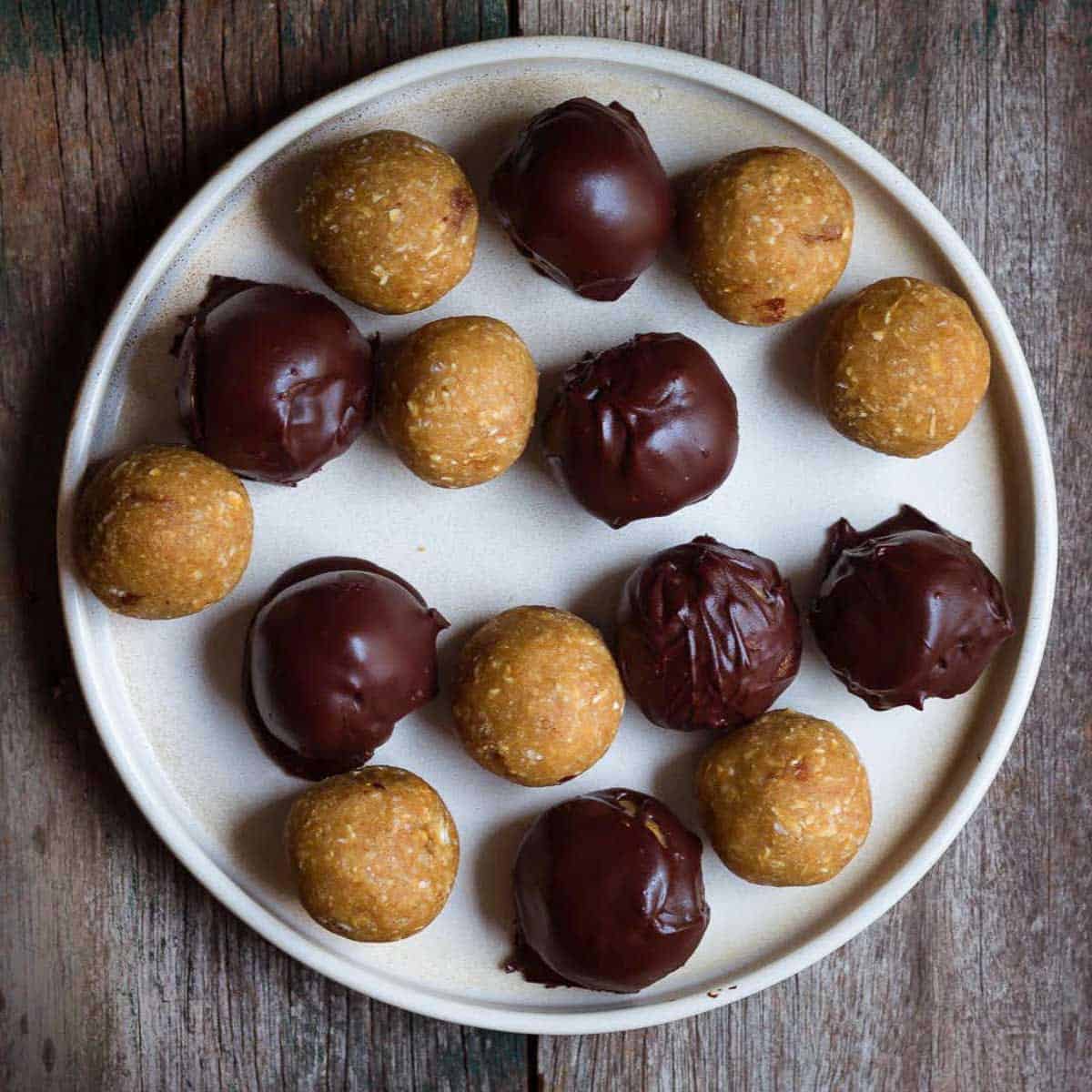Plain and chocolate covered balls on a plate.