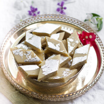 Kaju Katli on a silver serving tray.
