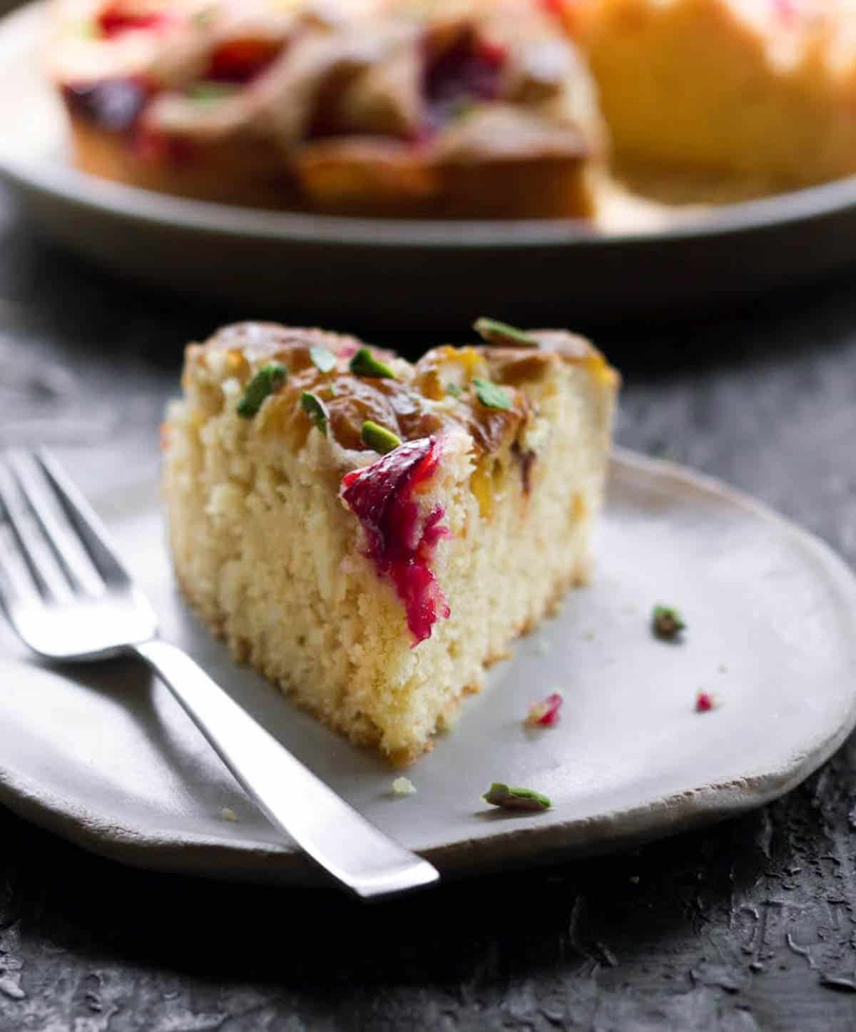 A slice of cake on a small plate with a fork.