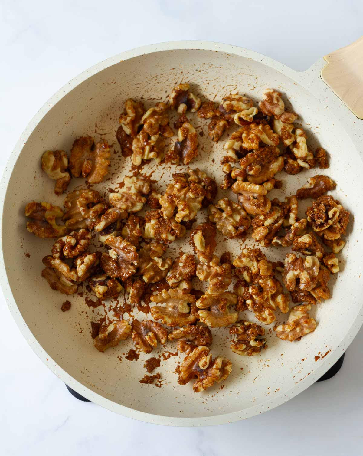 walnuts with brown sugar in a saucepan.